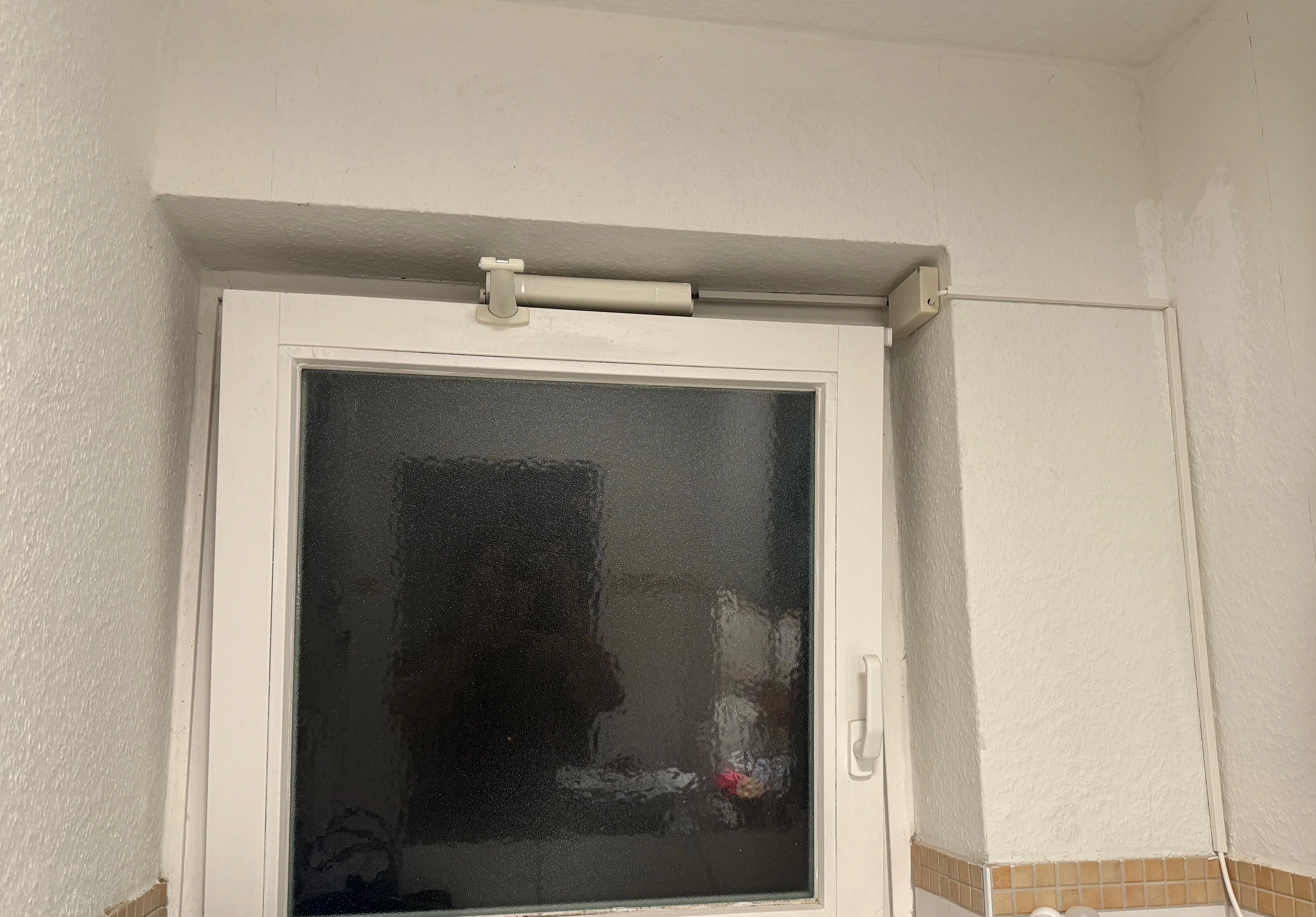 Picture of the bathroom window with the window opener installed